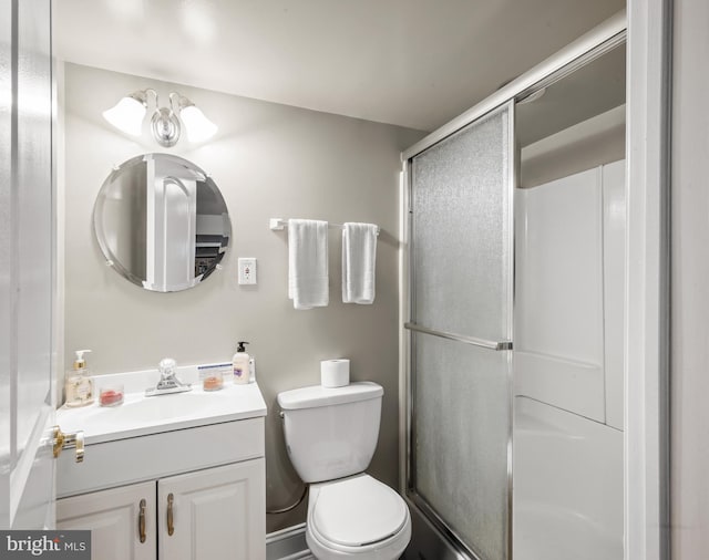 full bath with vanity, toilet, and a shower stall