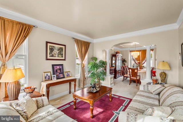 living area with carpet flooring, ornamental molding, ornate columns, and arched walkways