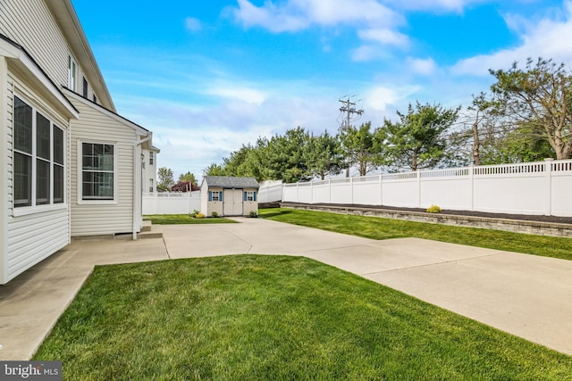 view of yard with a fenced backyard, an outbuilding, a patio, and a storage shed