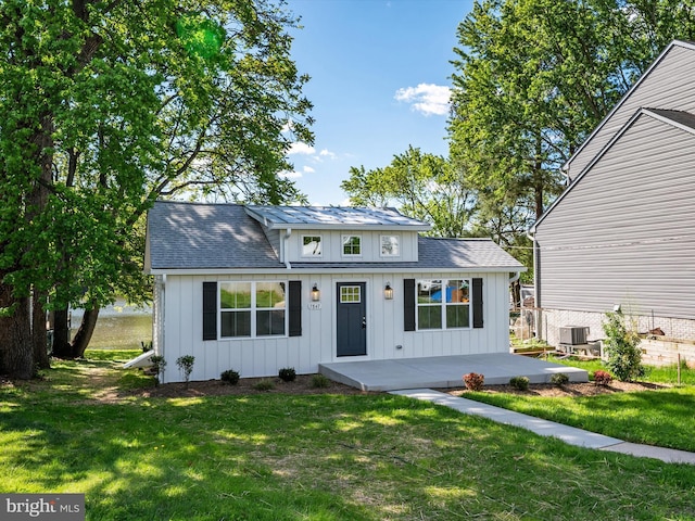 7847 Leymar Rd, Glen Burnie, MD 21060 - view of front of property featuring board and batten siding, central AC, and a front yard