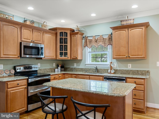 126 Boydton Plank Dr, Stephens City, VA 22655 - kitchen featuring light wood finished floors, a kitchen breakfast bar, appliances with stainless steel finishes, and a sink