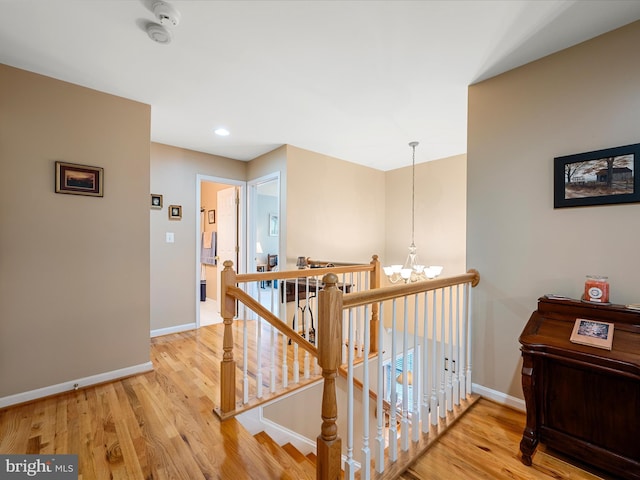 126 Boydton Plank Dr, Stephens City, VA 22655 - hall featuring light wood-style flooring, a notable chandelier, baseboards, and an upstairs landing