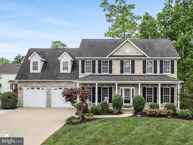 126 Boydton Plank Dr, Stephens City, VA 22655 - view of front facade featuring concrete driveway, brick siding, roof with shingles, and a front yard