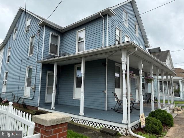 exterior space with covered porch and fence
