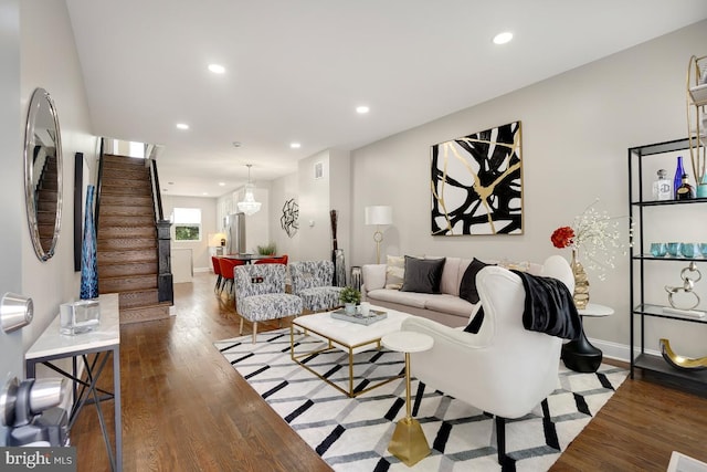 living room with stairway, wood finished floors, visible vents, and recessed lighting