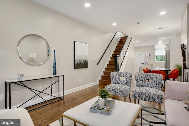 living room featuring stairs, wood finished floors, baseboards, and recessed lighting