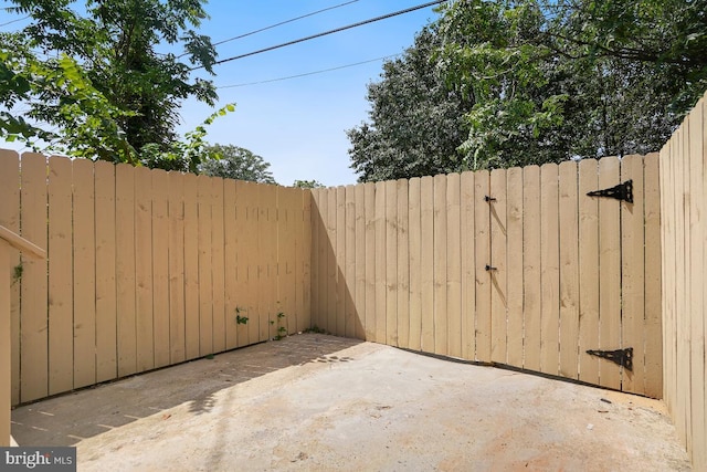 view of patio featuring a gate and fence