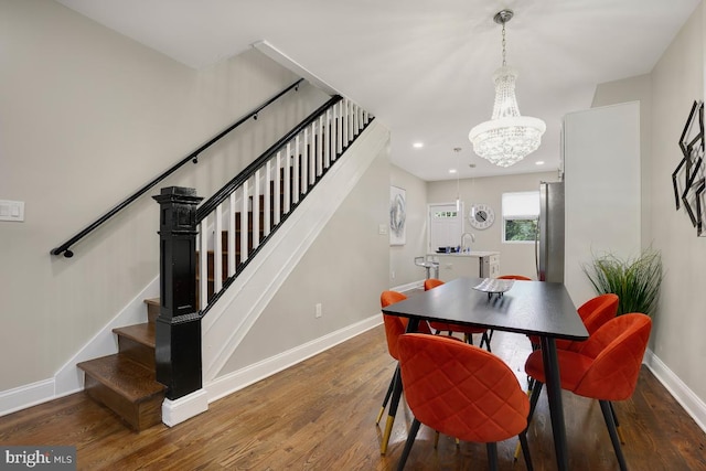 dining space featuring baseboards, stairs, and wood finished floors