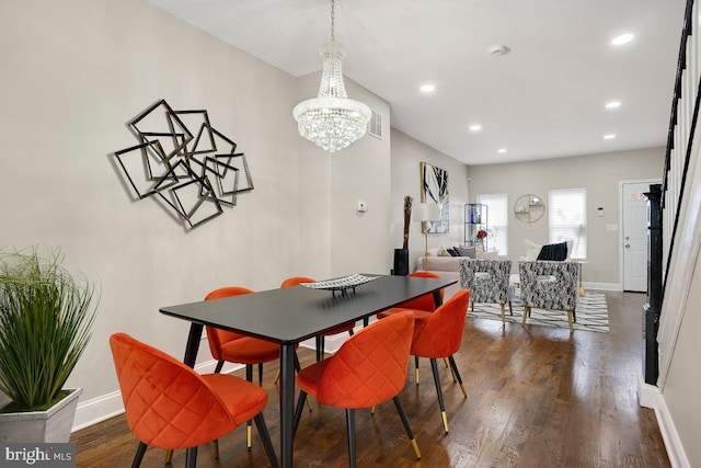 dining area with baseboards, dark wood-type flooring, a notable chandelier, and recessed lighting