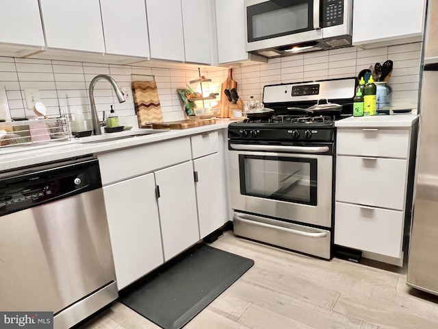 430 M St SW Unit N-205, Washington, DC 20024 - kitchen with appliances with stainless steel finishes, a sink, white cabinetry, and light countertops
