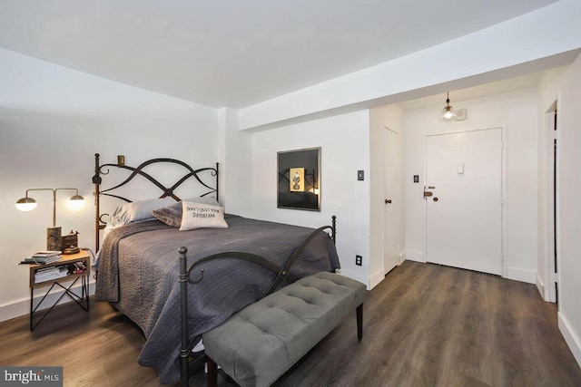 bedroom with wood finished floors and baseboards
