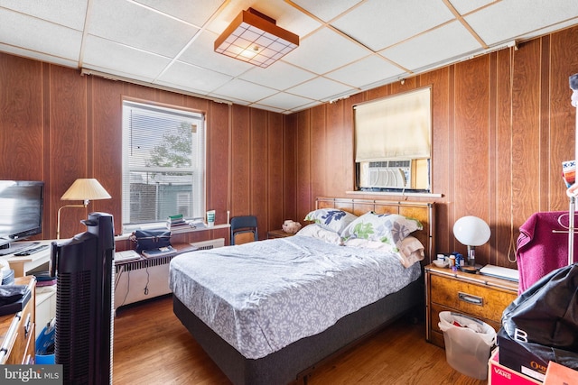5766 W Jefferson St, Philadelphia, PA 19131 - bedroom with a paneled ceiling, wood walls, cooling unit, and wood finished floors