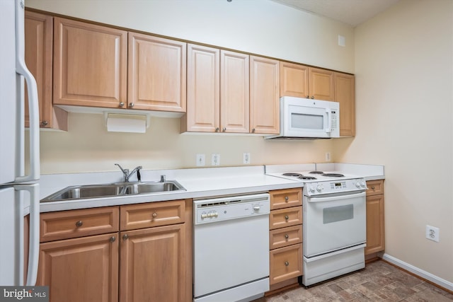 kitchen featuring light brown cabinetry, a sink, baseboards, white appliances, and light countertops