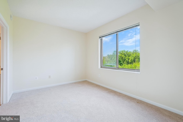 carpeted empty room with baseboards