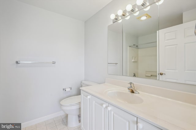 bathroom featuring tile patterned flooring, toilet, baseboards, and vanity