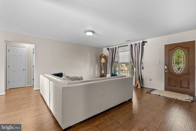 living room featuring wood finished floors and baseboards