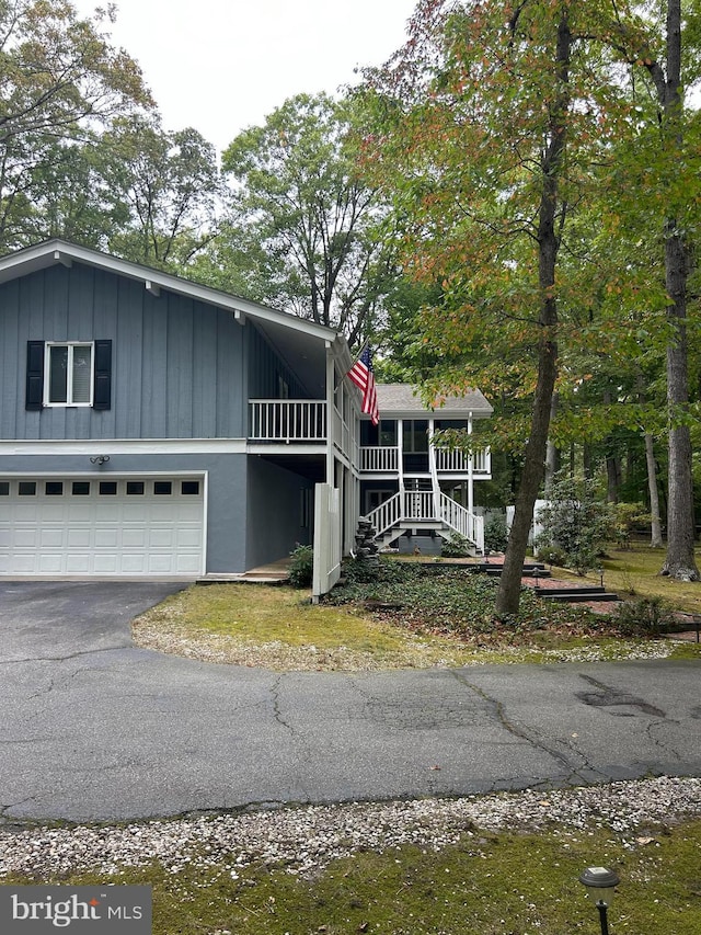 115 Carnoustie Rd, Dover, DE 19904 - view of front of property with board and batten siding, an attached garage, and driveway