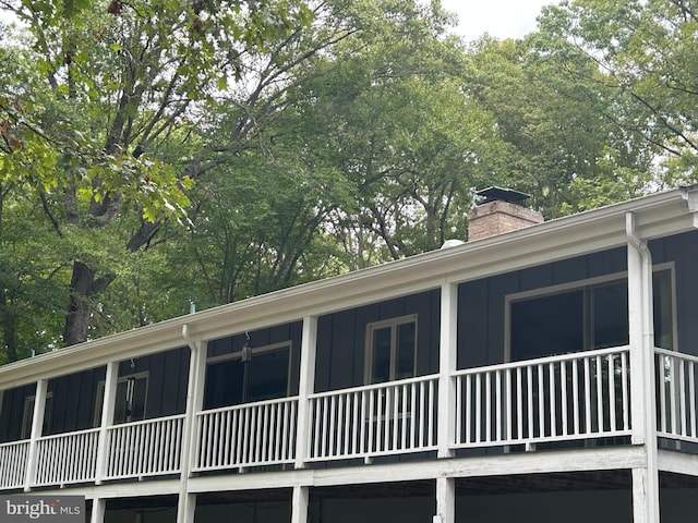 115 Carnoustie Rd, Dover, DE 19904 - view of property exterior with board and batten siding and a chimney