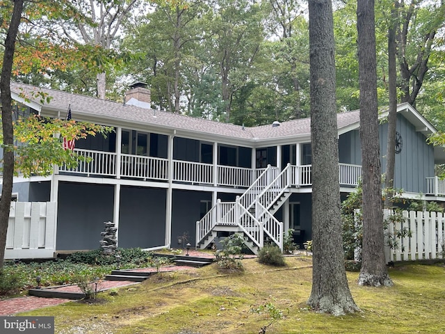 115 Carnoustie Rd, Dover, DE 19904 - rear view of property with a shingled roof, board and batten siding, stairway, and a chimney
