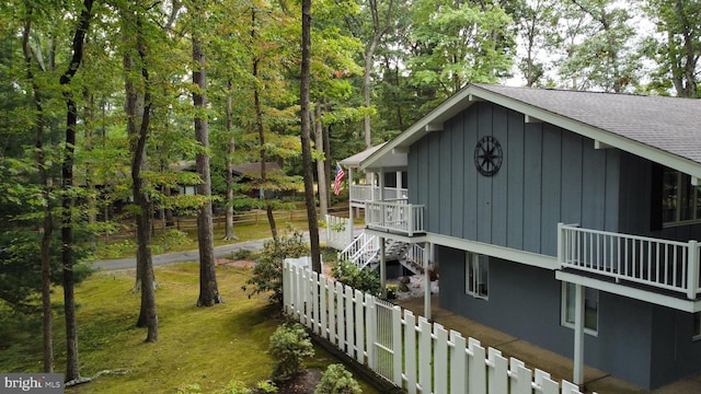 115 Carnoustie Rd, Dover, DE 19904 - view of property exterior featuring stairway, fence, and a shingled roof