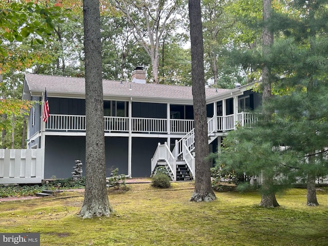 115 Carnoustie Rd, Dover, DE 19904 - rear view of house featuring stairway, roof with shingles, a sunroom, and a chimney