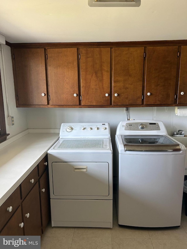 115 Carnoustie Rd, Dover, DE 19904 - laundry room with washing machine and dryer, light tile patterned flooring, and cabinet space