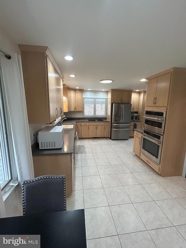 115 Carnoustie Rd, Dover, DE 19904 - kitchen with recessed lighting, light tile patterned floors, a sink, dark countertops, and stainless steel appliances
