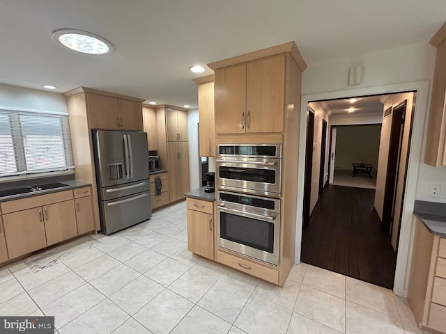 115 Carnoustie Rd, Dover, DE 19904 - kitchen with dark countertops, stainless steel appliances, light tile patterned flooring, and a sink