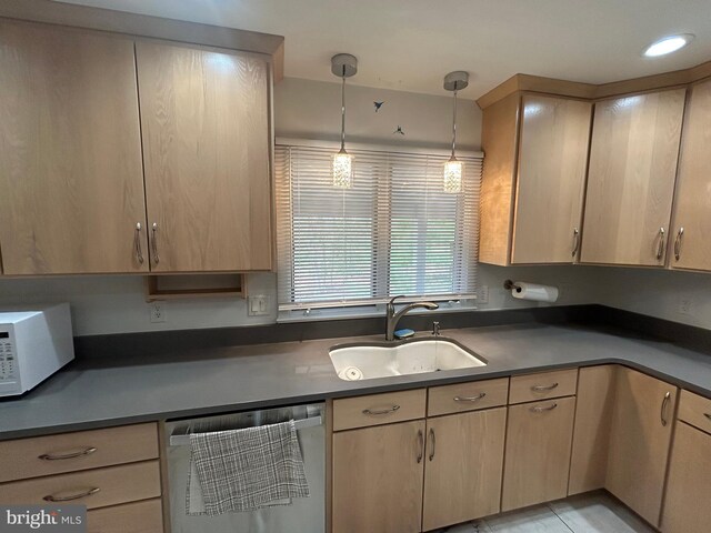 115 Carnoustie Rd, Dover, DE 19904 - kitchen featuring a sink, white microwave, dishwasher, light brown cabinets, and dark countertops