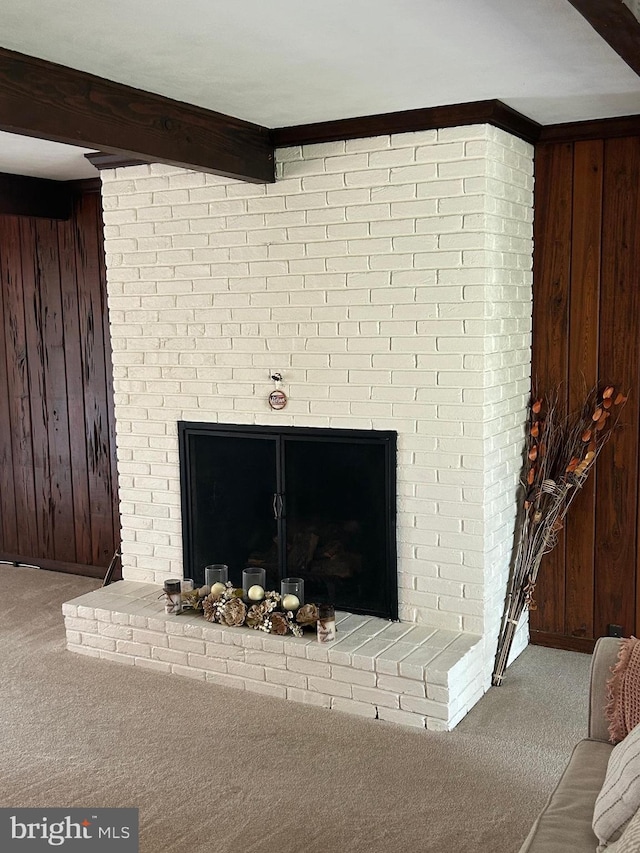 115 Carnoustie Rd, Dover, DE 19904 - room details featuring wooden walls, beam ceiling, a brick fireplace, and carpet floors