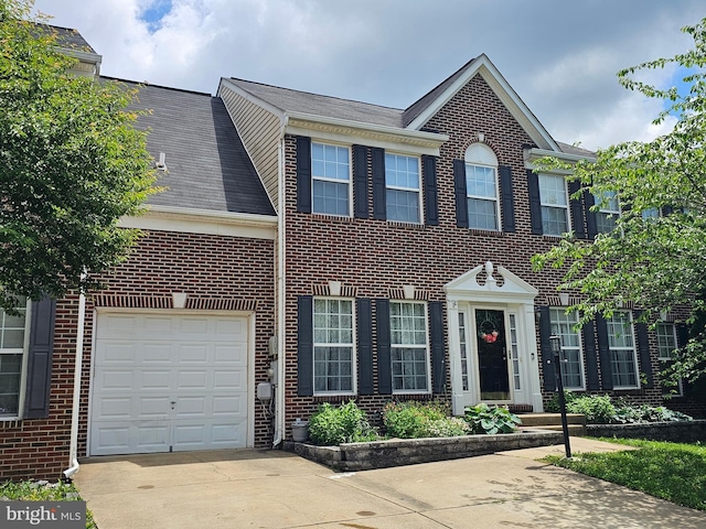 8645 Adrienne Pl, Manassas, VA 20110 - colonial-style house with brick siding, concrete driveway, and a garage