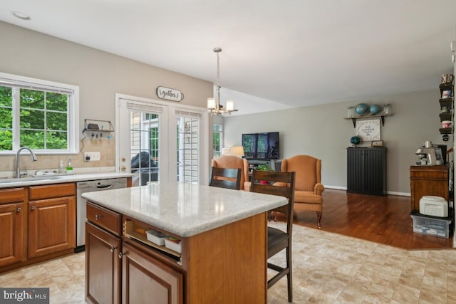 8645 Adrienne Pl, Manassas, VA 20110 - kitchen featuring a sink, dishwasher, a chandelier, open floor plan, and pendant lighting