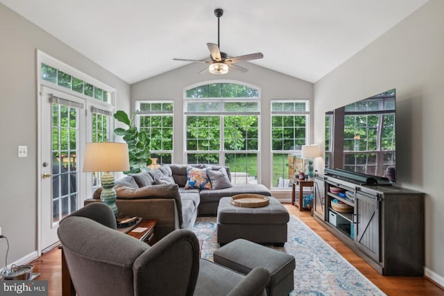 8645 Adrienne Pl, Manassas, VA 20110 - living room with plenty of natural light, a ceiling fan, vaulted ceiling, light wood-type flooring, and baseboards