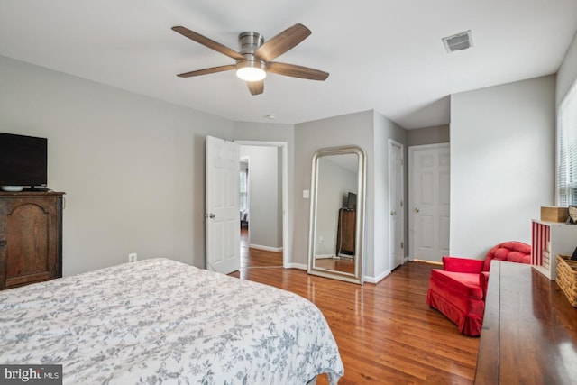 8645 Adrienne Pl, Manassas, VA 20110 - bedroom featuring wood finished floors, baseboards, multiple windows, and ceiling fan