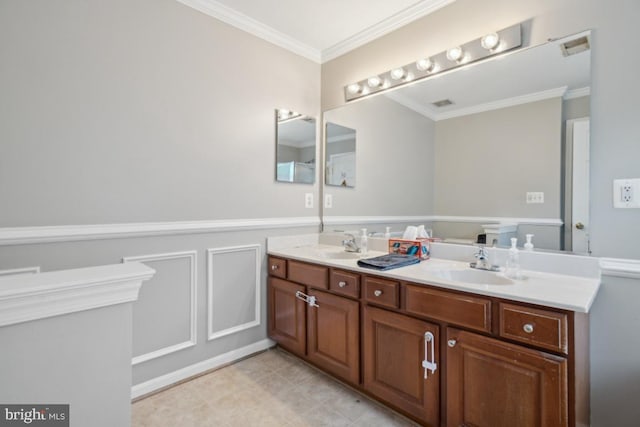 8645 Adrienne Pl, Manassas, VA 20110 - bathroom with double vanity, crown molding, and a wainscoted wall