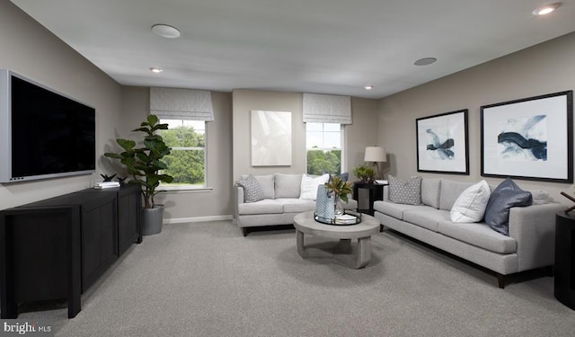 living area featuring plenty of natural light, light carpet, baseboards, and recessed lighting
