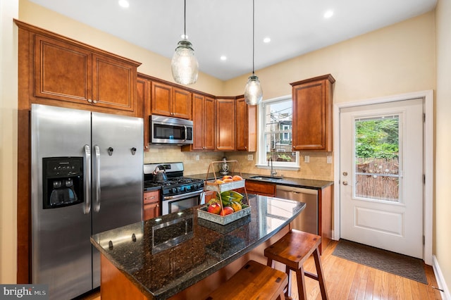 866 N 20th St, Philadelphia, PA 19130 - kitchen with appliances with stainless steel finishes, a sink, decorative backsplash, a breakfast bar area, and recessed lighting