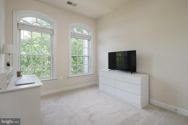 unfurnished bedroom with carpet, baseboards, visible vents, and multiple windows