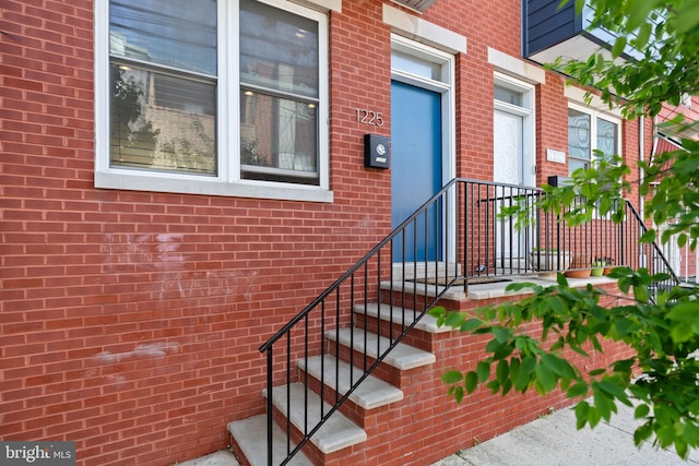property entrance featuring brick siding
