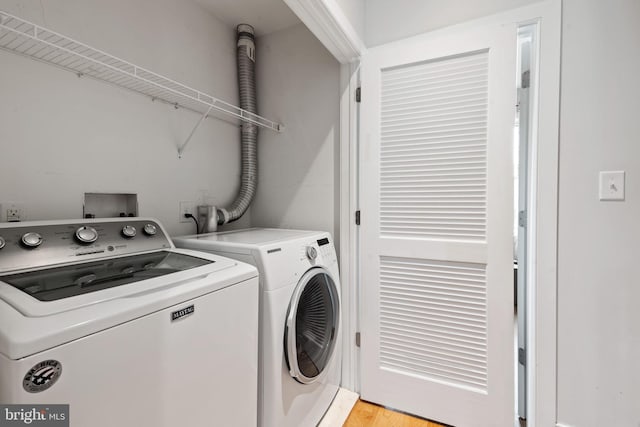 laundry room with separate washer and dryer and laundry area