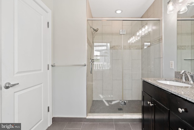 bathroom with tile patterned floors, vanity, a shower stall, and recessed lighting