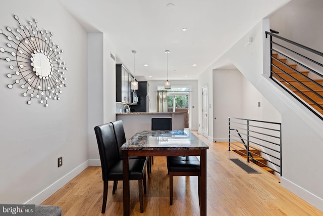 dining space featuring recessed lighting, baseboards, and light wood-style floors