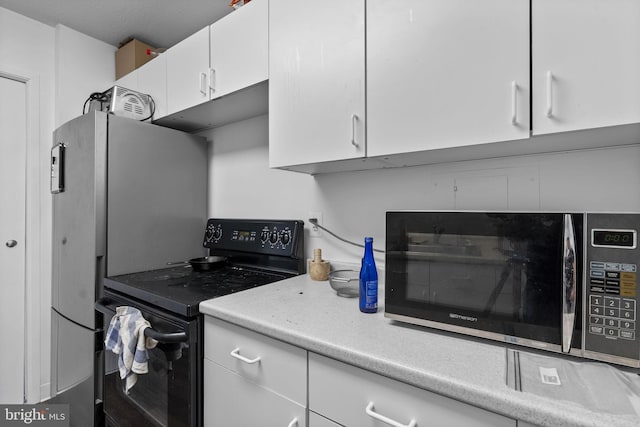 1 E University Pkwy Unit 1502, Baltimore, MD 21218 - kitchen with light countertops, appliances with stainless steel finishes, and white cabinetry