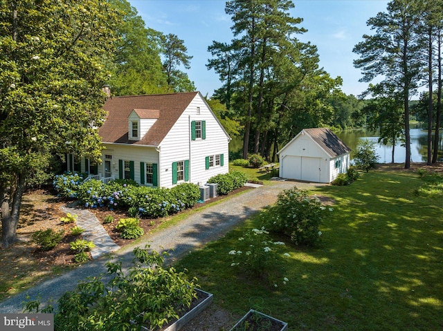 view of property exterior featuring an outdoor structure, a lawn, a water view, and a garage