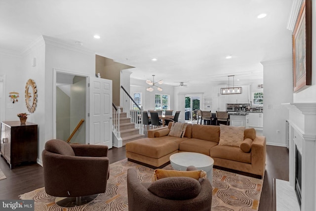 760 Whitetail Cir, King Of Prussia, PA 19406 - living room featuring a fireplace with flush hearth, dark wood finished floors, crown molding, recessed lighting, and a chandelier