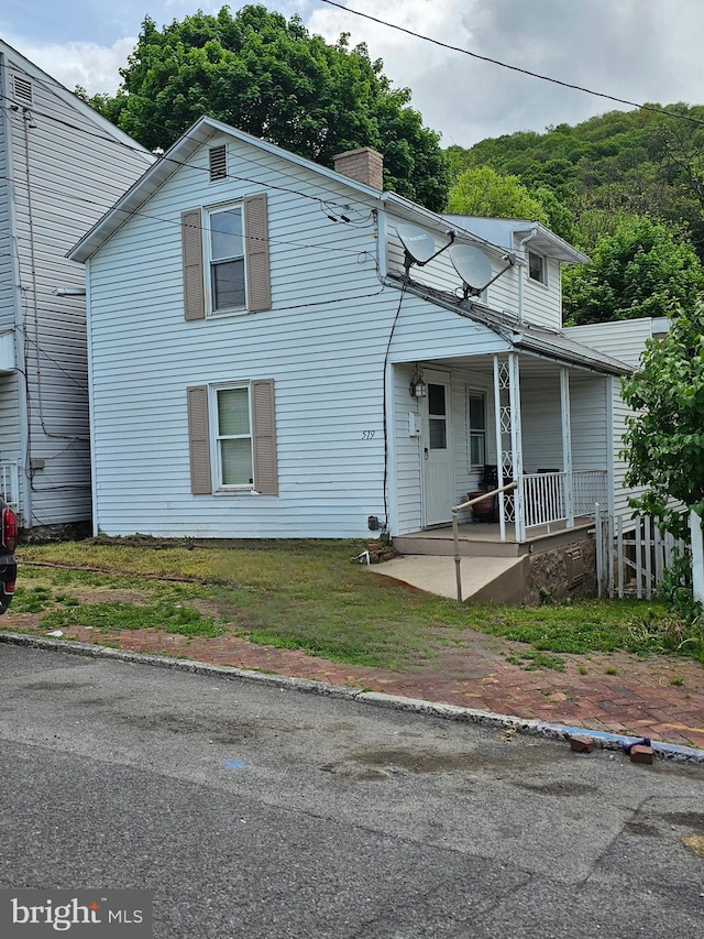519 Furnace St, Cumberland, MD 21502 - traditional home with a chimney, a front lawn, and covered porch