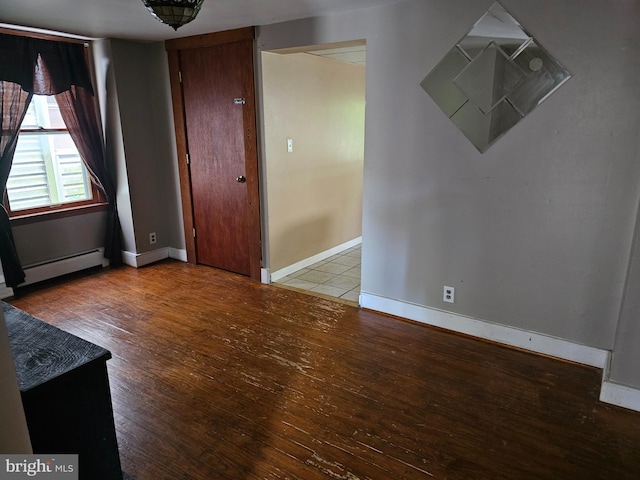 519 Furnace St, Cumberland, MD 21502 - unfurnished room with a baseboard heating unit, hardwood / wood-style floors, and baseboards
