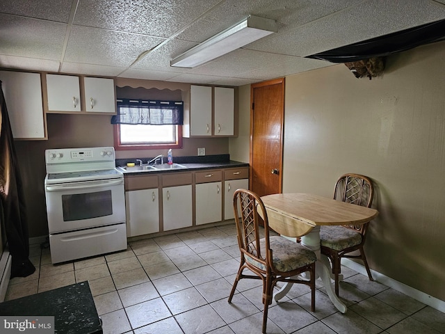 519 Furnace St, Cumberland, MD 21502 - kitchen with light tile patterned floors, a sink, dark countertops, white cabinets, and electric range