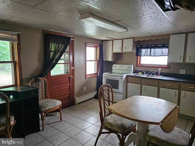 519 Furnace St, Cumberland, MD 21502 - kitchen featuring light tile patterned floors, a sink, white range with electric cooktop, white cabinetry, and a baseboard radiator