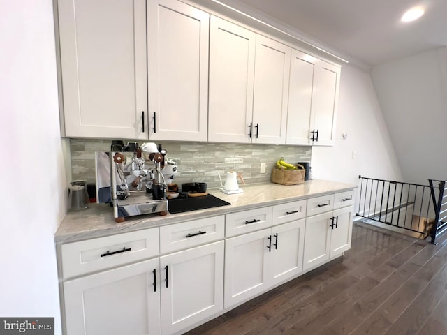 bar with tasteful backsplash and dark wood finished floors